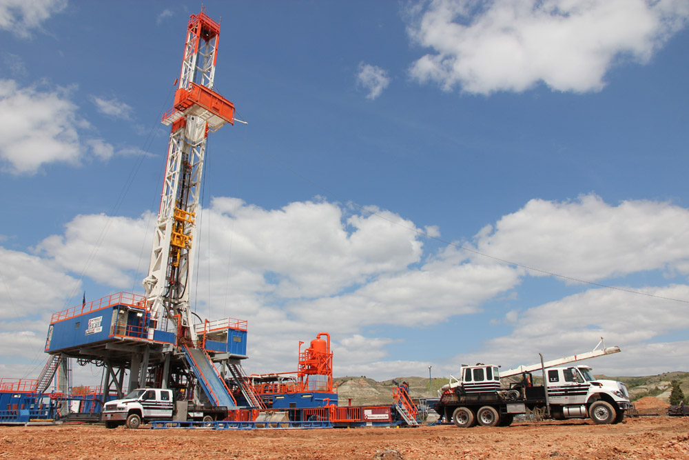 Trucks bringing equipment to a drilling site