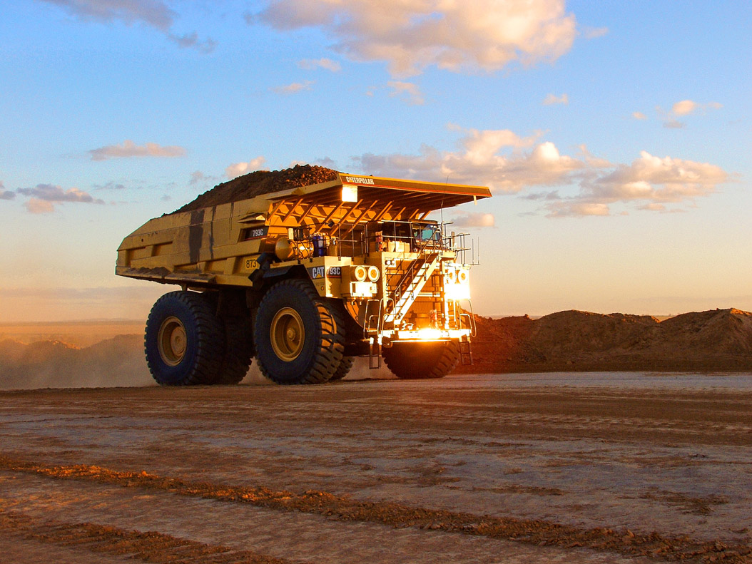 Large trucks are used at a coal mine to help move materials.