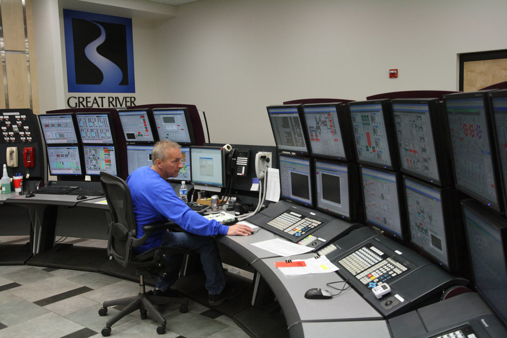 A power plant operator monitors equipment.