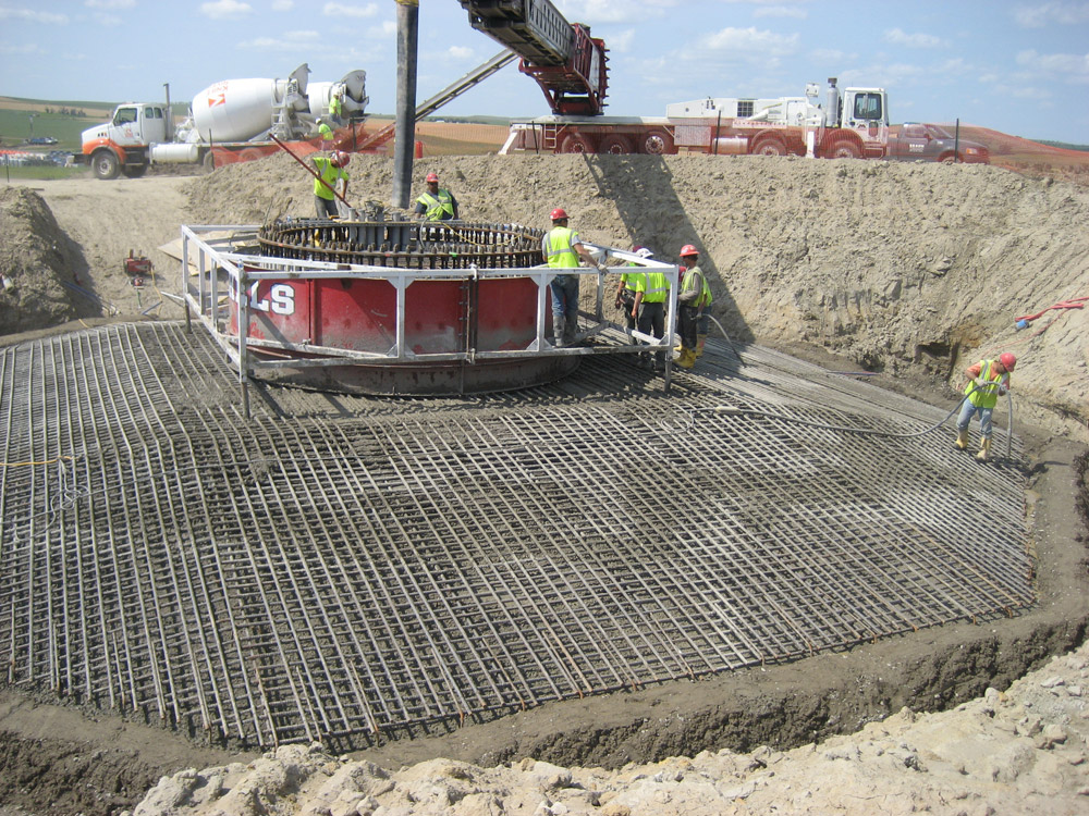 A grid of steel is arranged to prepare the foundation of the wind tower.